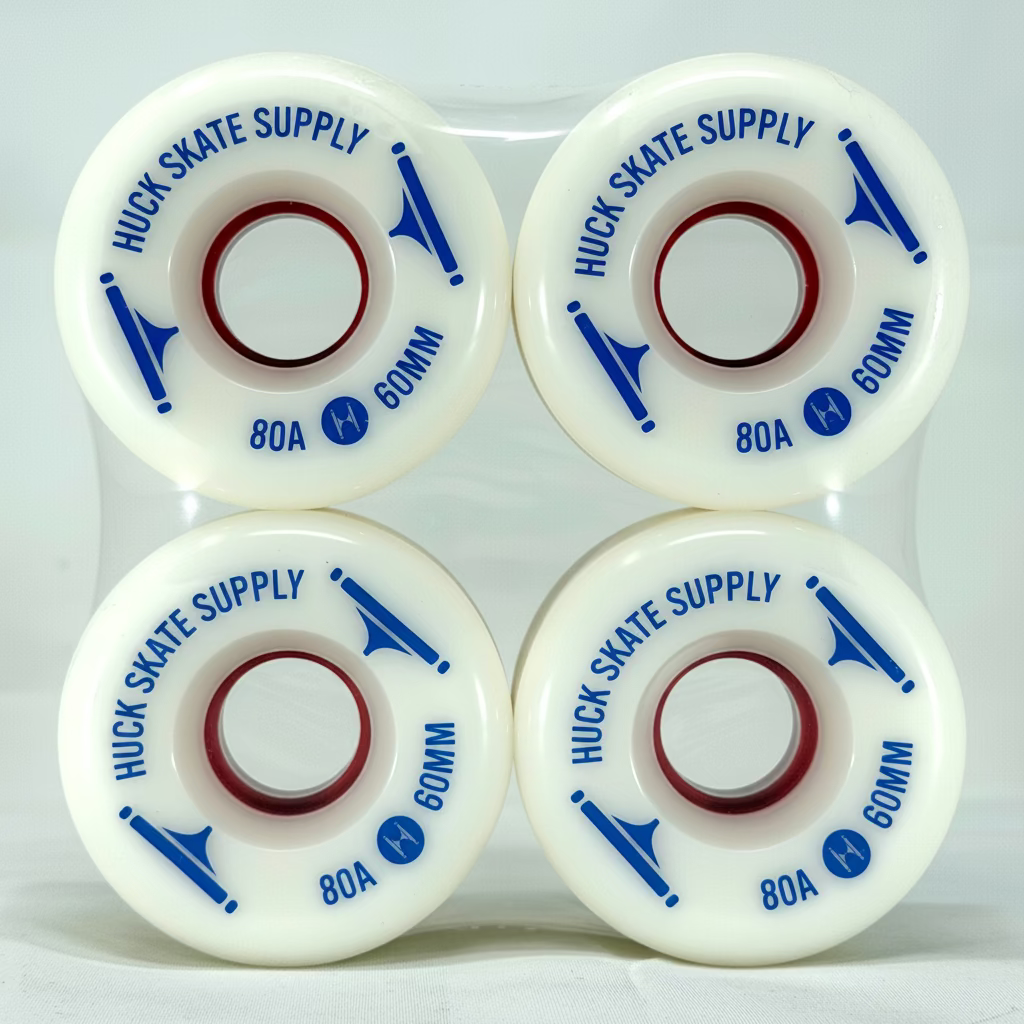 Four white skateboard wheels with blue text on a white background