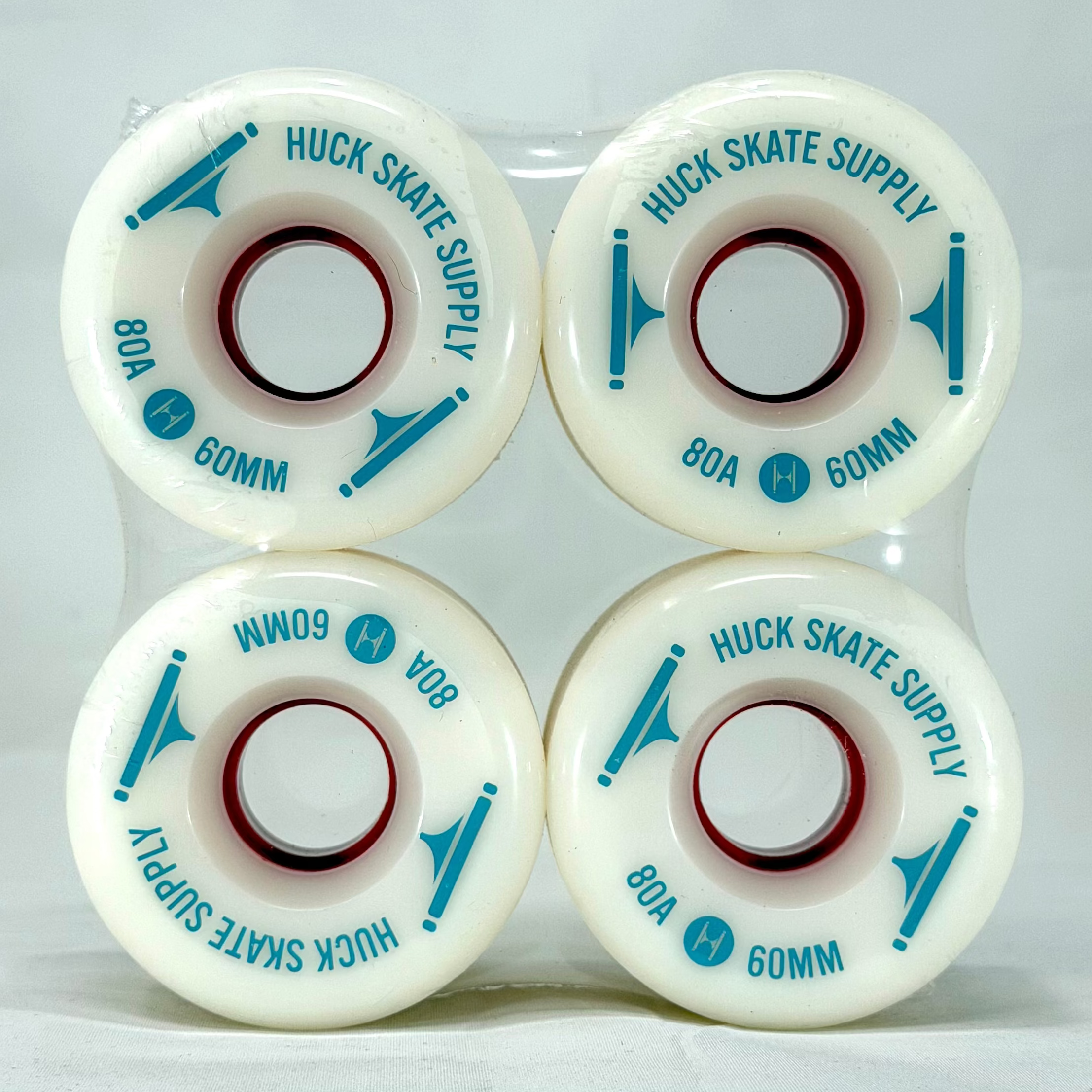 Four white skateboard wheels with baby blue text on a white background